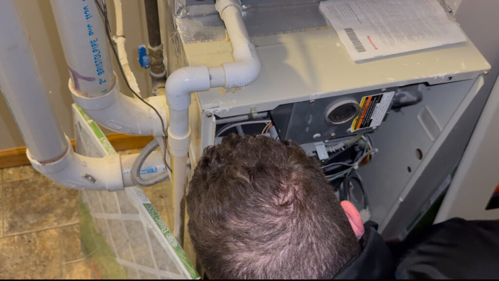 Core Services technician working inside a furnace